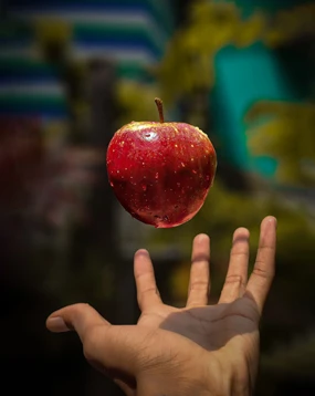 Tossing a red apple