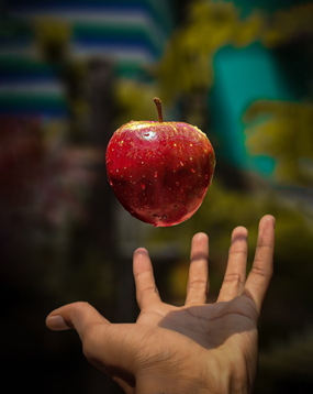 Tossing a red apple
