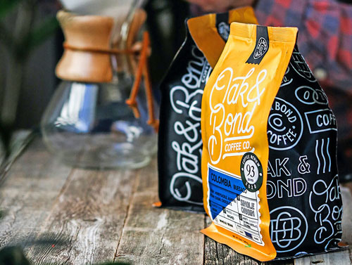 branded custom printed coffee bags sitting on wood table