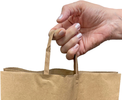 Hand holding handles of paper grocery bag with reinforced handles