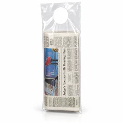 Plastic Doorknob Bags hanging from door handle with newspaper