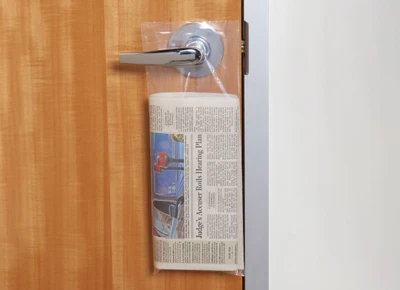 Plastic Doorknob Bags hanging from door handle with newspaper