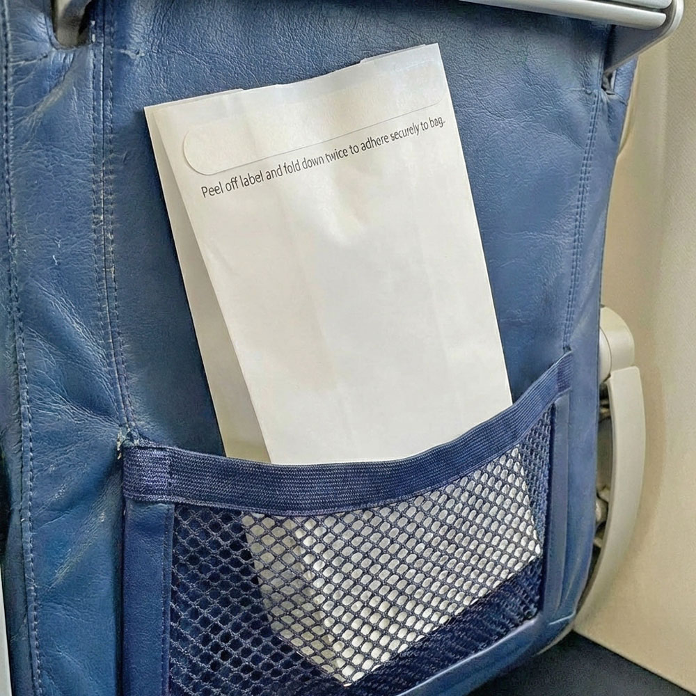4.5 x 2.5 x 8.5 Air Sickness Emesis Bags with Adhesive Seal in the Back of a Commercial Airline Seat