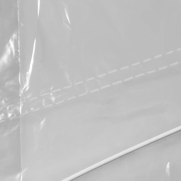 21 x 4 x 38 Clear Dry Cleaning Bag Sloped Shoulder Top Close up of 21x4x38 .5 Mil Clear Plastic Garment Bags and Dry Cleaning Bags on Rolls for Slacks and Shirts Sloped Shoulder Top