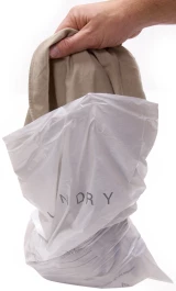 Place Clothes in Tear Strip Hospitality Laundry Bag 