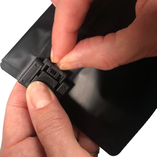 6.69 x 4 Child Resistant Exit Bags Black 6.69 x 4 Child Resistant Exit Bags Fingers Pushing Childproof Lock into Place