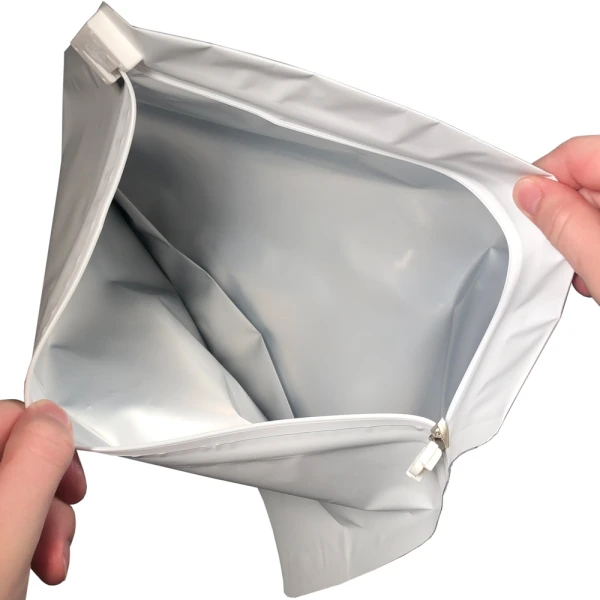 12.5 x 9 Child Proof Exit Bags White 12.5 x 9 Child Proof Exit Bags Hands Holding Bag Open