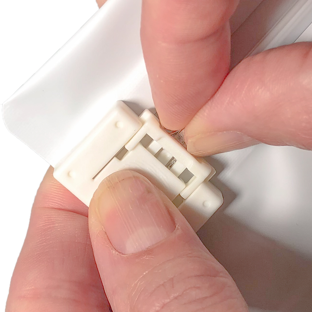 White 6.69 x 4 Child Proof Exit Bags Fingers Pushing Childproof Lock into Place