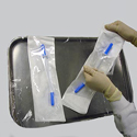 Medical professional removing IV Decanter from Sterile Pouch