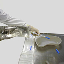 Medical professional removing spout cap to dispenser needed contents from IV