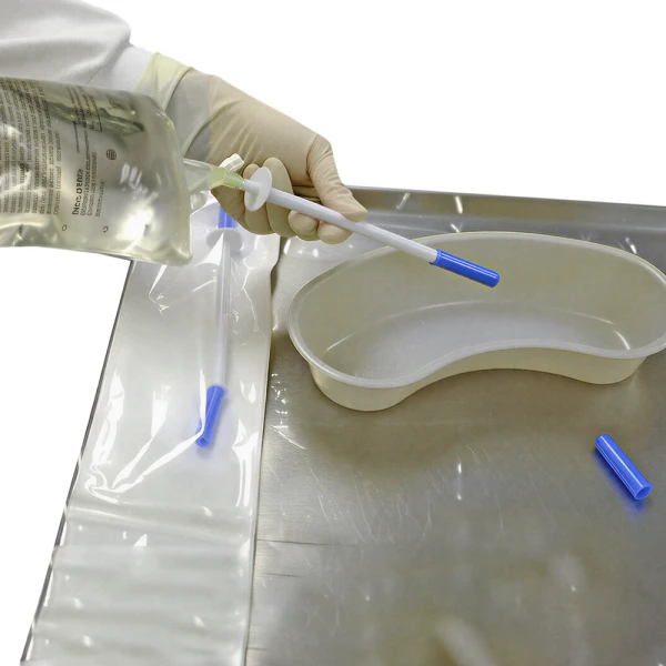 2. Hold the product (still in the container pouch) and remove the protective cap from the spiked end. Medical professional removing protective cap off of IV