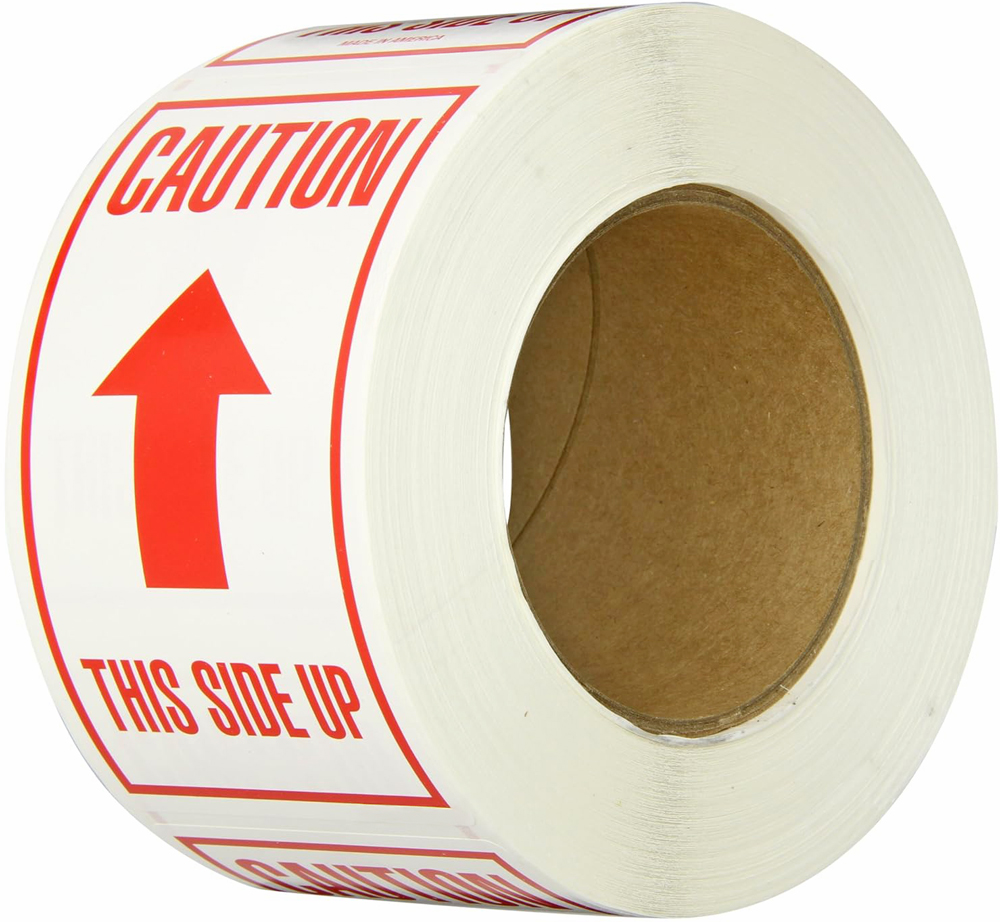 Roll of Red Text Caution This Side Up on a white label stock background