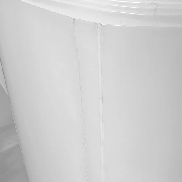 Clear Plastic Dust Collector Bags - 6 MIl Perforation and Bottom Seal Close up of 38 x 72 Super Heavy Duty Plastic Dust Collecting Bags Perforation and Bottom Seal