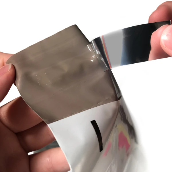 12 x 15.5 Poly Mailers with Tear Perforation Showing Tape 12 x 15.5 Poly Mailers with Tear Perforation Fingers Pulling Nonstick Slip Back from Tape