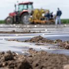 Black plastic sheeting being used on Farm with Tractor