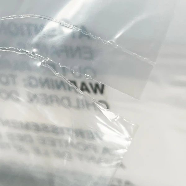 18 x 24 1.5 Mil Auto Bags with Suffocation Warning Flat Front 18 x 24 1.5 Mil Pre-Opened Bags On Roll For Automated Bagging Perforation