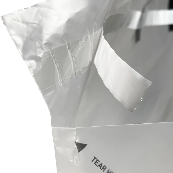 21 x 15 + 10 Tamper-Resistant Delivery Bag 21 x 15 + 10 Tamper-Resistant Delivery Bag Close Up of Tape with Protective Paper Slip Peeled Back