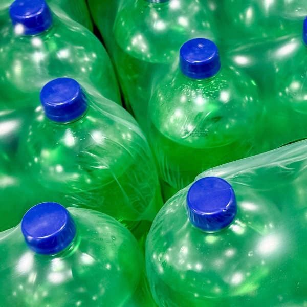 Securing Green Plastic Soda Bottles with 22" x 4200' .002 mil Heat Shrink Film