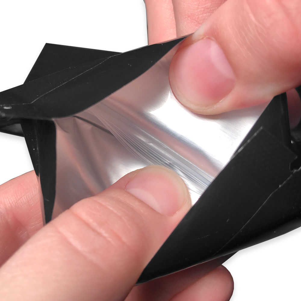 Black 3.75 x 4 Child Resistant Stand Up Pouches Zipper Fingers Demonstrating Pulling Open the Bag by the Zipper