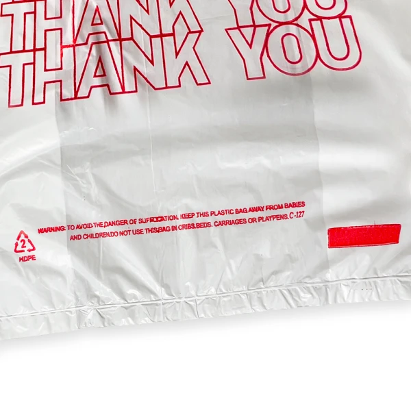 6 x 3 x 12 Thank You Shopping Bags 0.65 Mil Thank You Print Suffocation Warning Close up of 6 x 3 x 12 Thank You Shopping Bags 0.65 Mil Thank You Print Suffocation Warning on Bottom Front of Bag