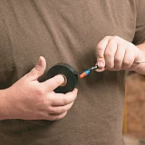 0.75x20 Black Electrical Tape being used by person in brown shirt