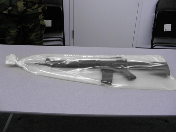 14x60 6 mil VCI Weapon Bags on table with military personal standing guard