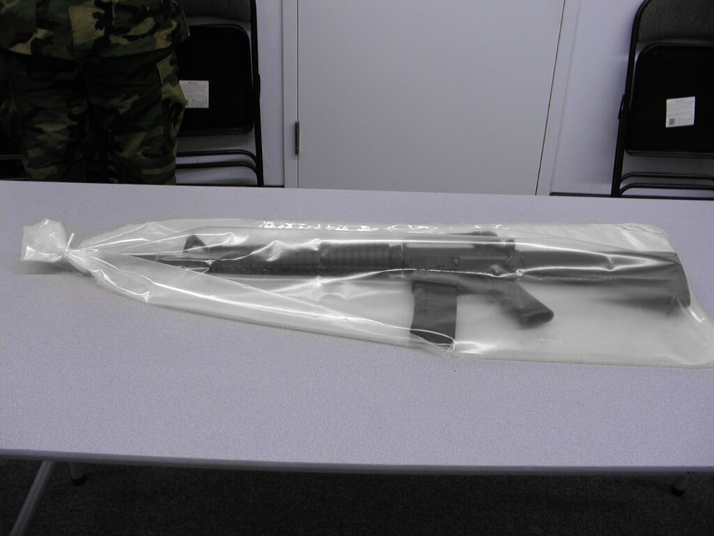 14x60 6 mil VCI Weapon Bags on table with military personal standing guard