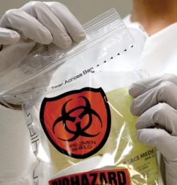 Easy tear off section of specimen shield bags with lab technician